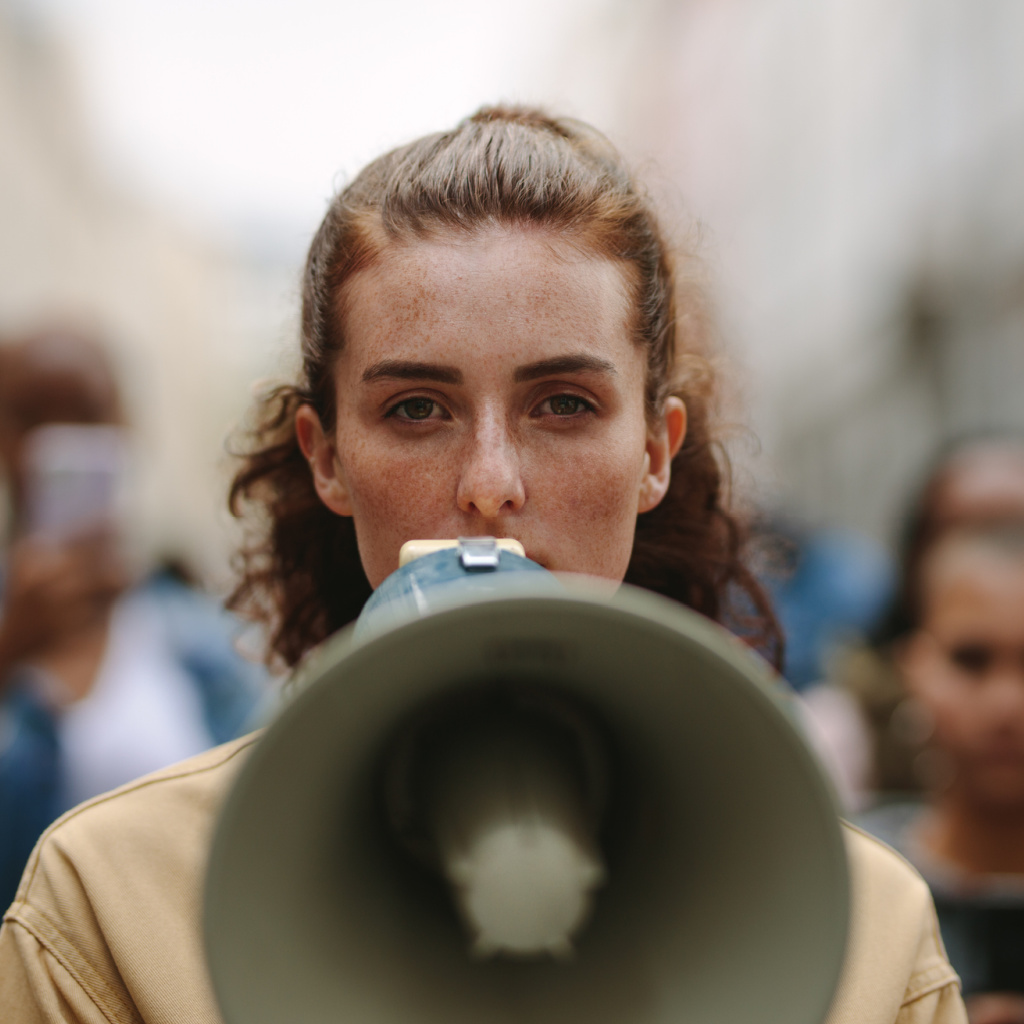 Woman Speaking into Megaphone | When Misanthropes Love Humanity | Public Square Magazine | I Love Humanity but I Hate Humans | Love of Humanity | Challenges of Loving Mankind